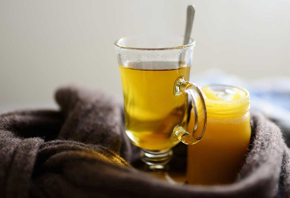 Glass cup of herbal tea with local honey in a jar, natural honey Nottingham for healthy tea ritual