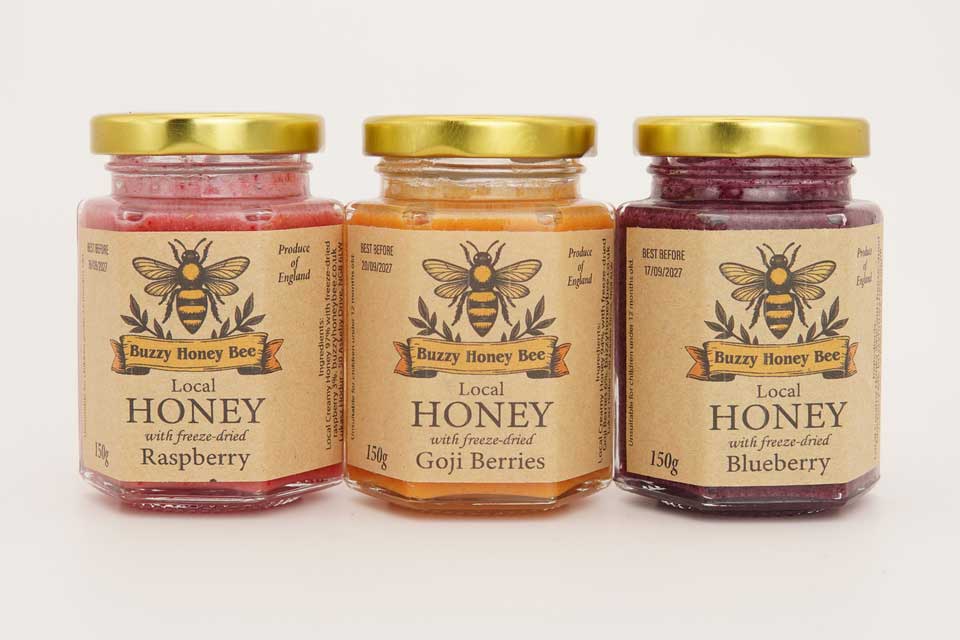Creamed honey jars with freeze-dried raspberry, goji berries and blueberry