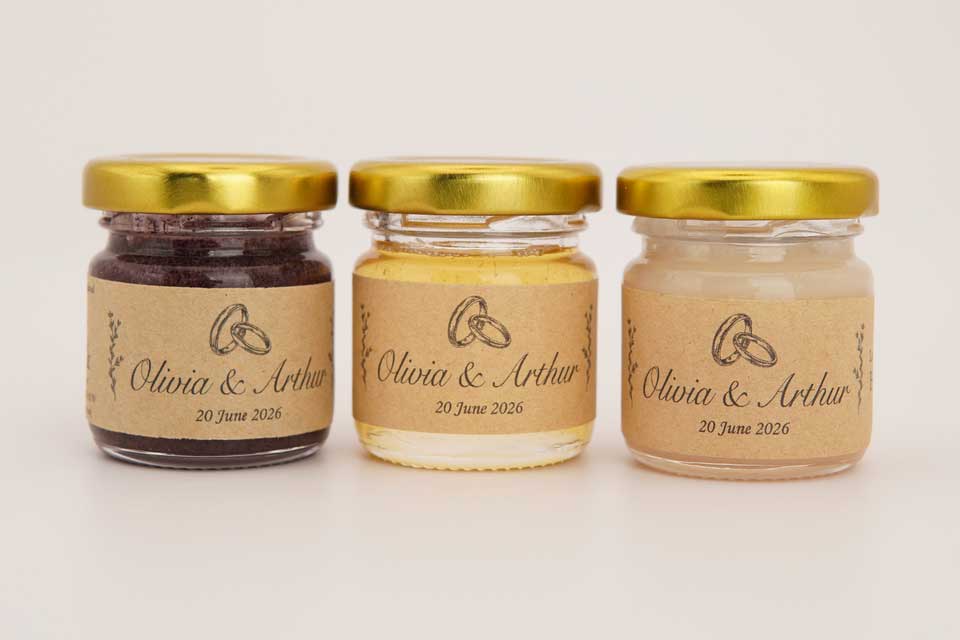 Three honey wedding favours in 50 g jars with personalised names and date
